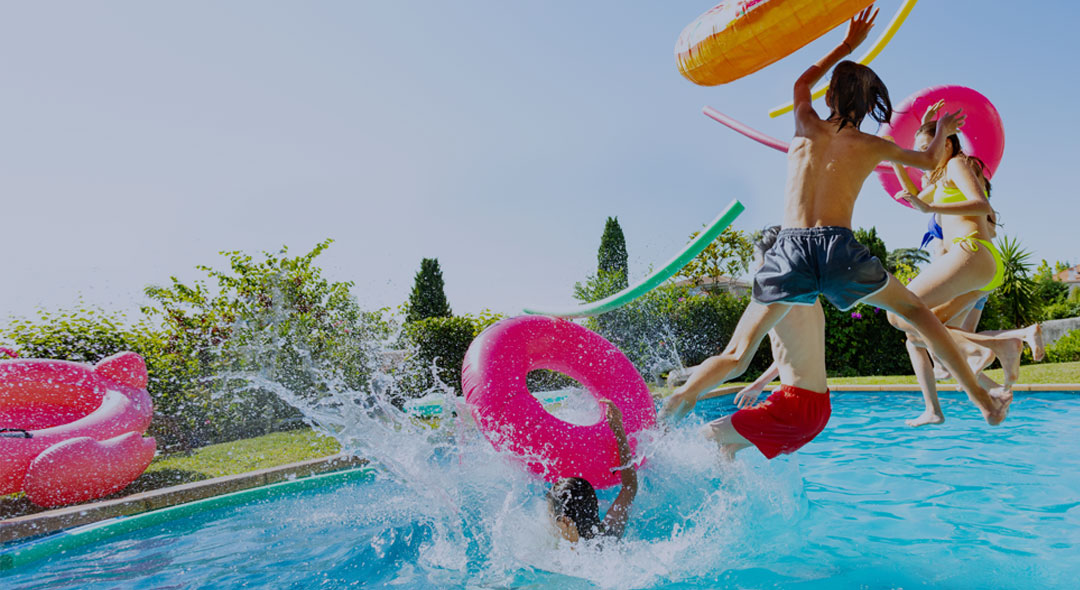 This is an image of children jumping in a pool.